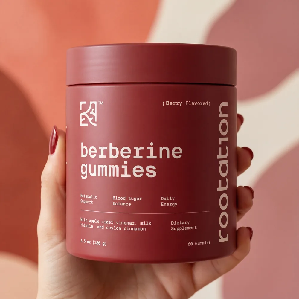 A hand holding the Rootation berberine gummies jar